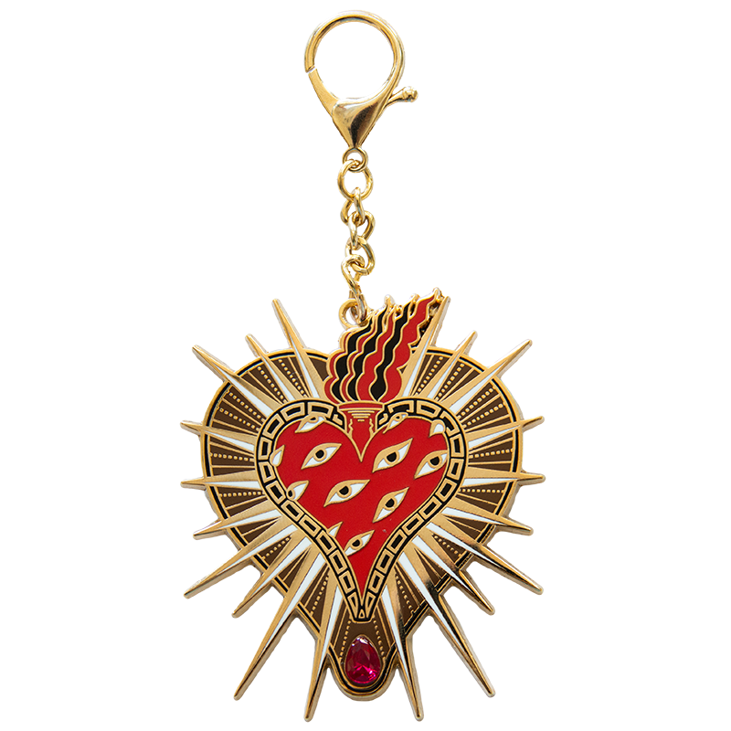 A cool tattoo heart purse charm made with 18k gold and a pear cut ruby.