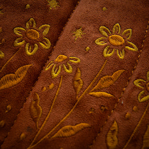 Detailed embroidery of yellow flowers and gold stars for witchcore style. 