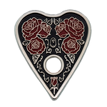 A gothic style enamel pin of a ouija planchette wih roses. 