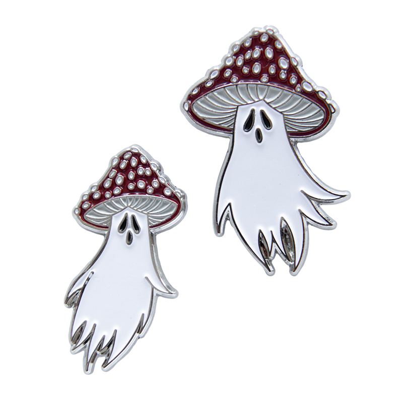 Two enamel pins of ghosts with mushrooms on their heads. Silver toned metal, red, white, and black enamel. 