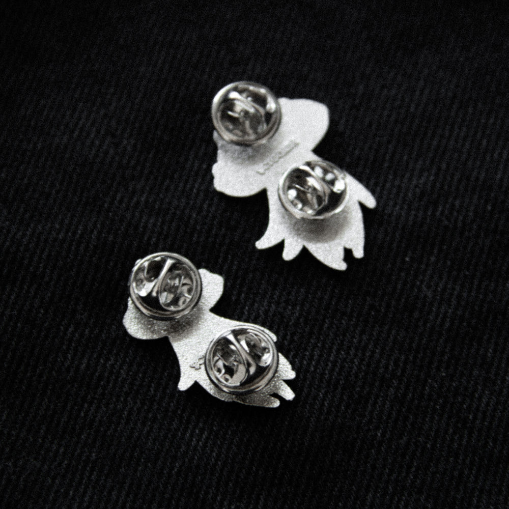 Clasps on the back of silver ghost broaches.