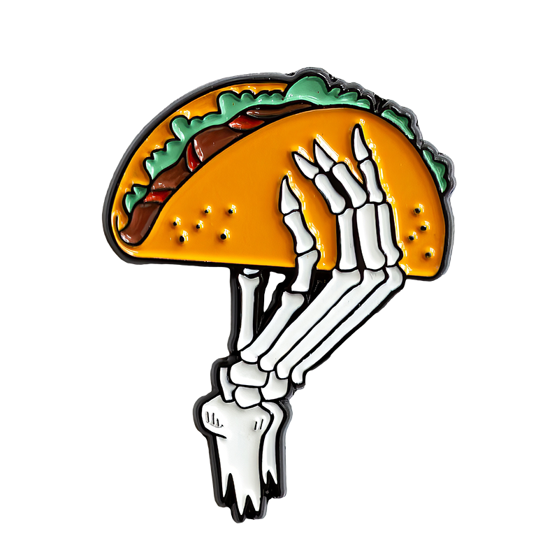 A cool enamel pin of a skeleton hand holding a taco for men's and women's unisex fashion.
