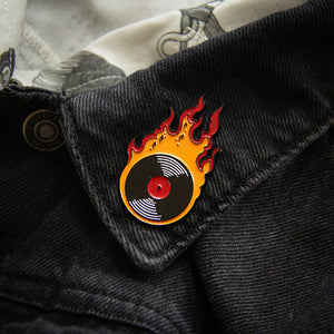Music themed fashion accessory and jewelry of a vinyl record with flames.