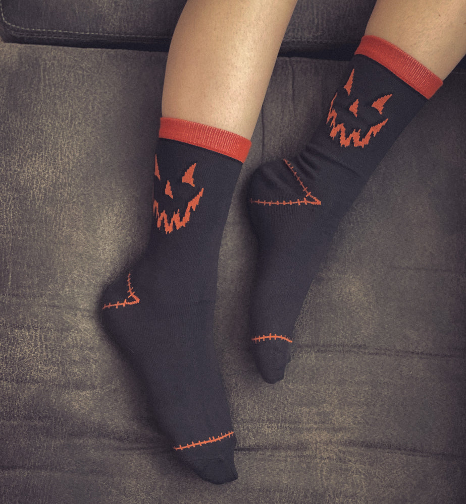 Spooky unisex halloween socks with jack-o-lantern faces.