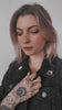 Video of an alternative fashion girl wearing a black denim jacket with enamel pins