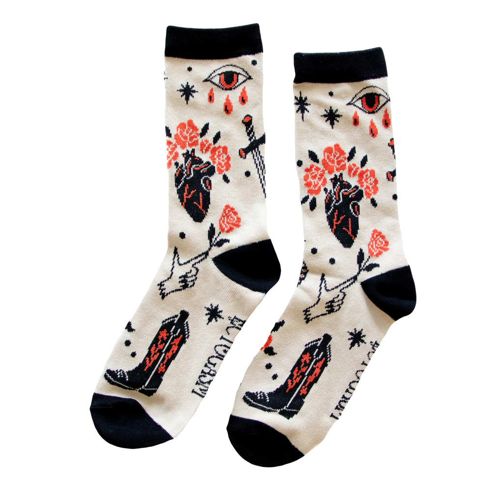 Cool men's and women's socks with a pattern of skulls, snakes, roses, daggers, and more tattoo art.
