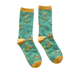 Ectogasm unisex crew socks in teal and gold. Pattern features stars, clouds, and a skull shaped moon, drawn in a vintage style. 