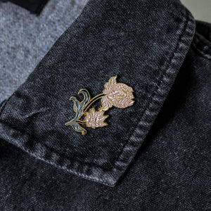An elegant flower brooch on a denim jacket for women's spring fashion and style. 