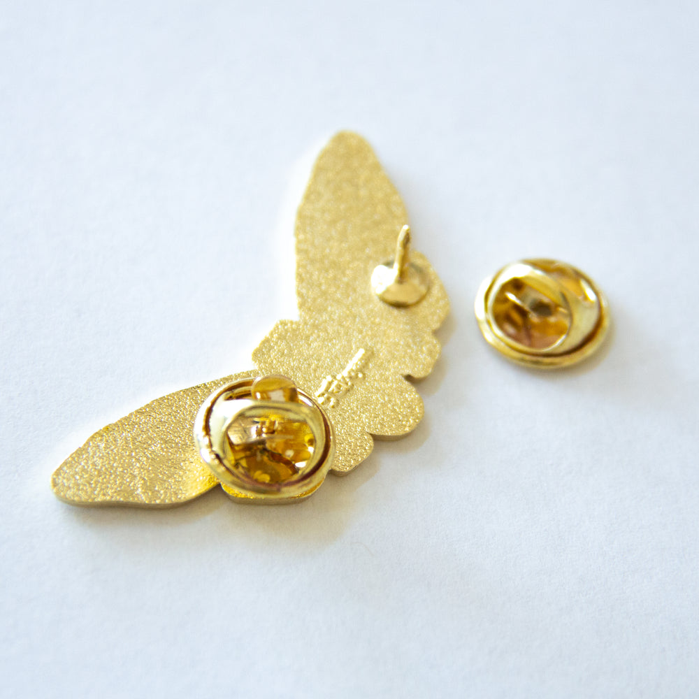 Two metal clasps on the back of a winged taxidermy bug enamel pin. Gift for people who like collecting curios and oddities.