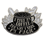 A witchy enamel pin of a cup of coffee with the quote, "I take my coffee the way I take my magic."