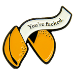 A funny enamel pin of a fortune cookie. 