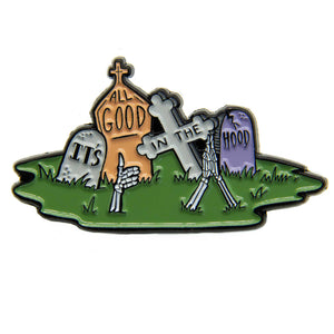 A cool lapel pin of headstones with skeleton hands popping up from the ground.