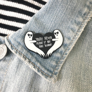 a funny ghost lapel pin on a denim jacket. 