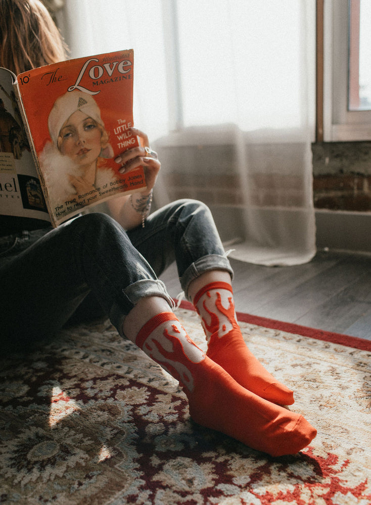 A woman wearing sheer red fire socks for rock n' roll fashion. 