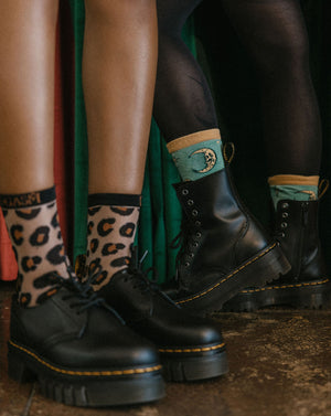 Vintage witch fashion socks with skull moon and stars in yellow and teal. 