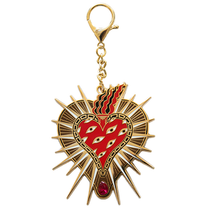 A cool tattoo heart purse charm made with 18k gold and a pear cut ruby.