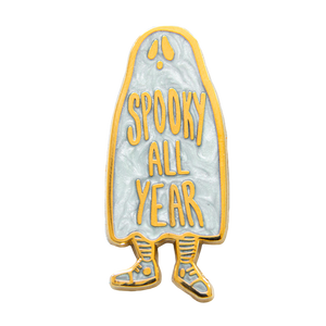 A "Spooky All Year" ghost enamel pin plated with 18k gold with pearl enamel. Hard enamel design.