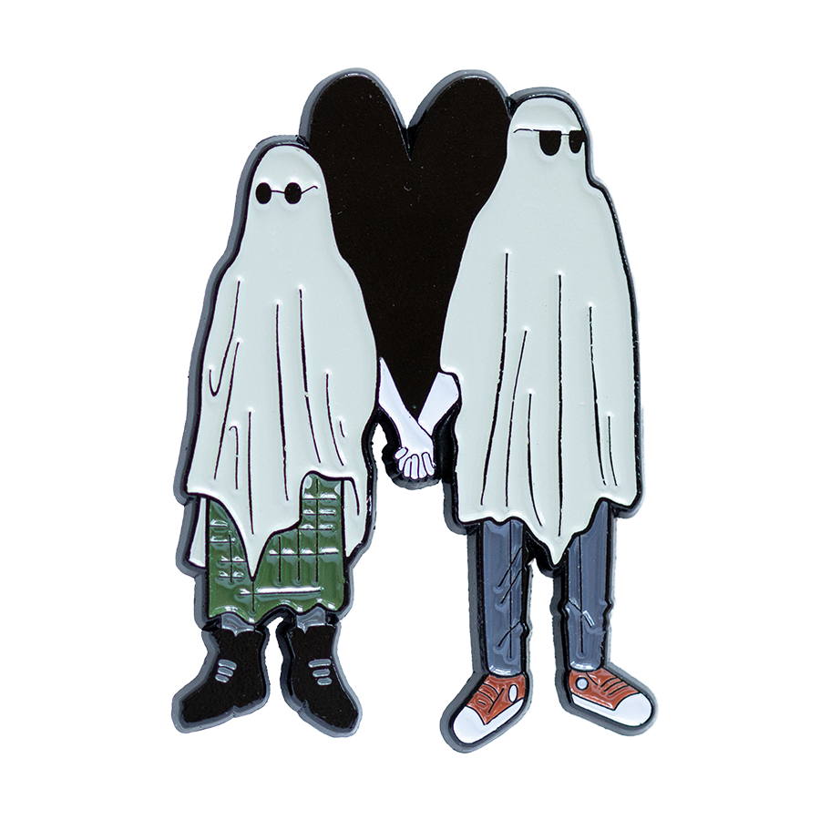 A creepy cute enamel pin of two emo sheet ghosts holding hands in front of a heart. 