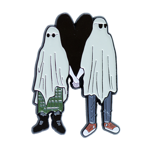 A creepy cute enamel pin of two emo sheet ghosts holding hands in front of a heart. 