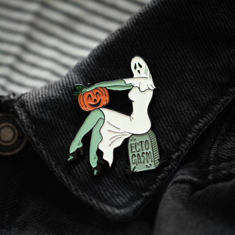 A lapel pin accessory of a pinup zombie ghost for Halloween style. 