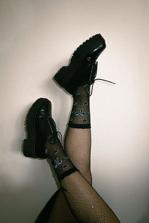 Alternative fashion sheer heart socks in black.