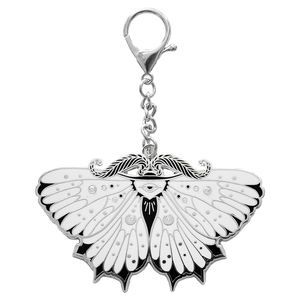 A stylish purse charm of a moth. Made with sterling silver and white moissanite gemstones.