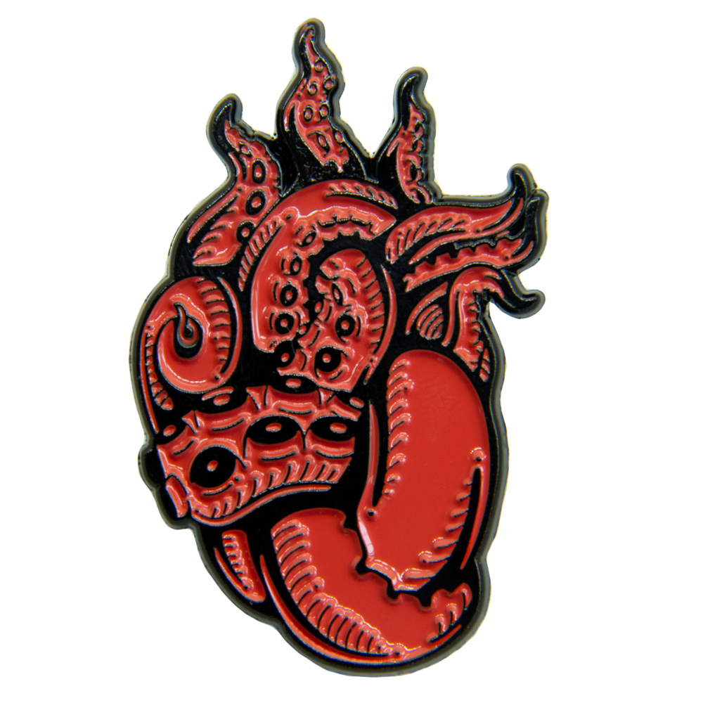 A red and black enamel pin of a heart made out of tentacles. 