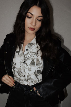 An alt fashion woman wearing a cool button down shirt with a unique print.