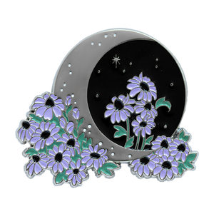 A witch aesthetic enamel pin of a crescent moon with night sky, stars, and purple flowers. 