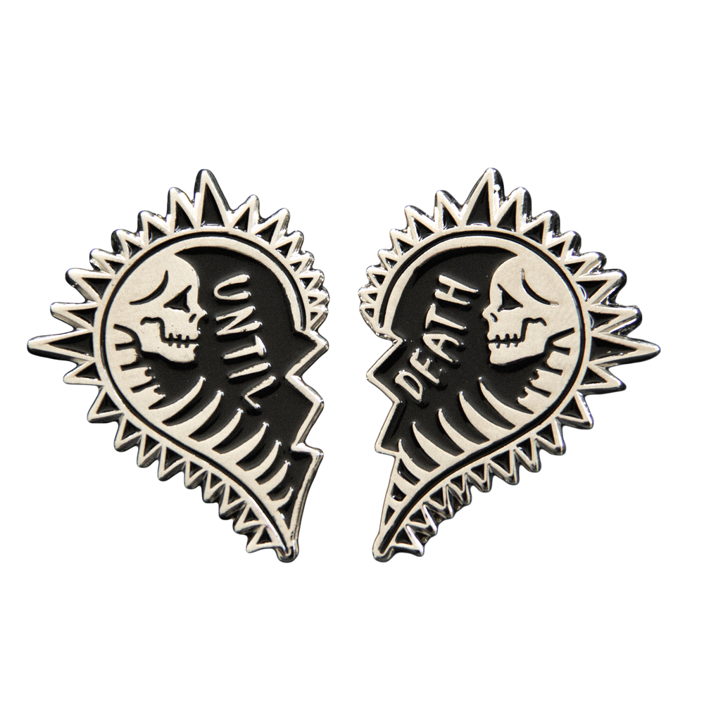 A gothic wedding themed enamel pin set of two halves of a heart with a skeleton in each side and the quote, "Until Death". Black enamel with silver metal. 