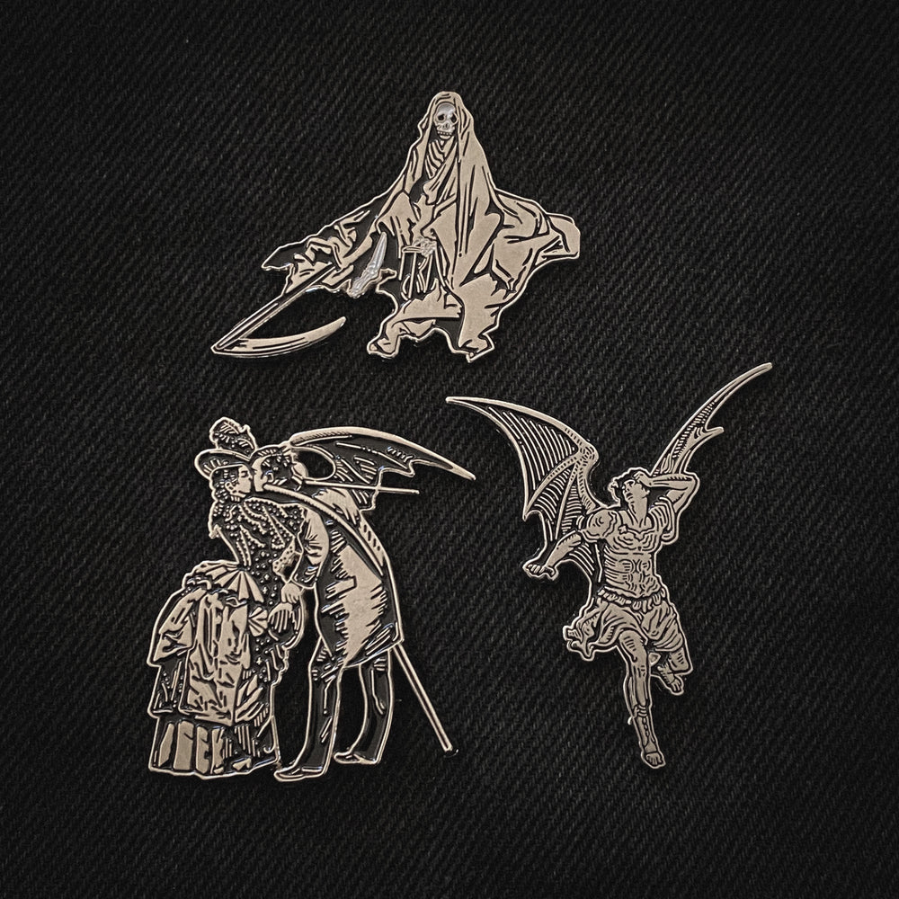 A collection of spooky black and silver enamel pins with art by Gustave Dore. 