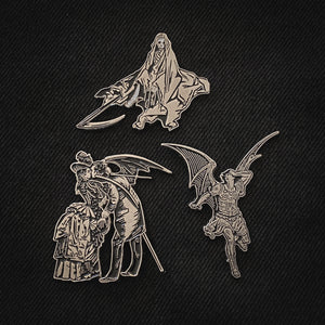 A collection of spooky black and silver enamel pins with art by Gustave Dore. 