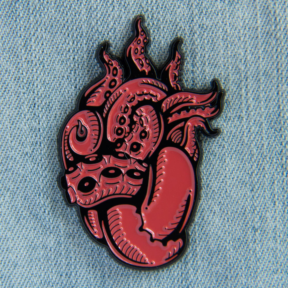 A cool, ocean themed enamel pin of tentacles shaped like a human heart. 