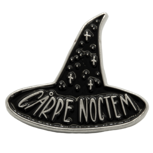A black and silver lapel pin of the quote, "Carpe Noctem" for spooky goth fashion. Designed by artist Ectogasm. 