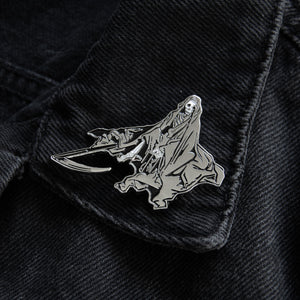 Black and silver grim reaper enamel pin for punk and metal fashion.