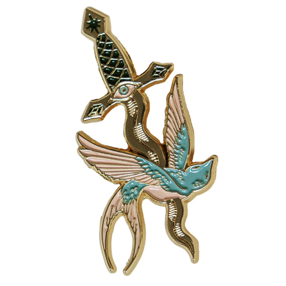 An enamel pin of a swallow and a dagger, inspired by American traditional tattoo artwork. 