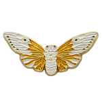 A cool insect pin of a ghost cicada in white and gold.