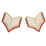 A lapel pin of an open book in gold and red. 