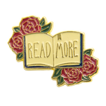 A cute dark academia style enamel pin of a library book with the quote, "Read More."