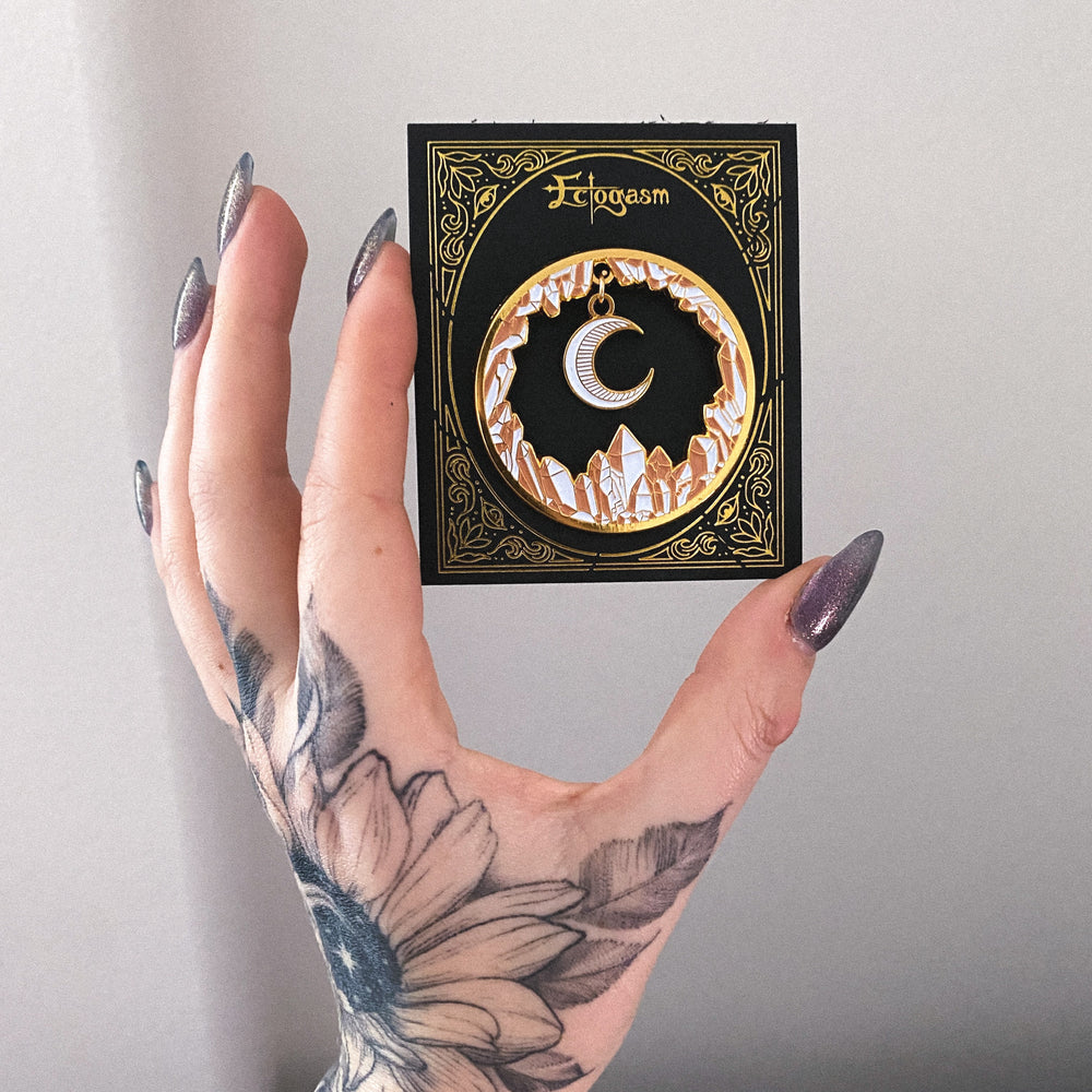 A beautiful gold enamel pin for women featuring crystals and a moon for witchy, spiritual fashion.