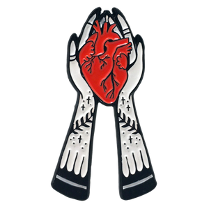 Ectogasm enamel pin gift of hands holding an anatomical heart. 