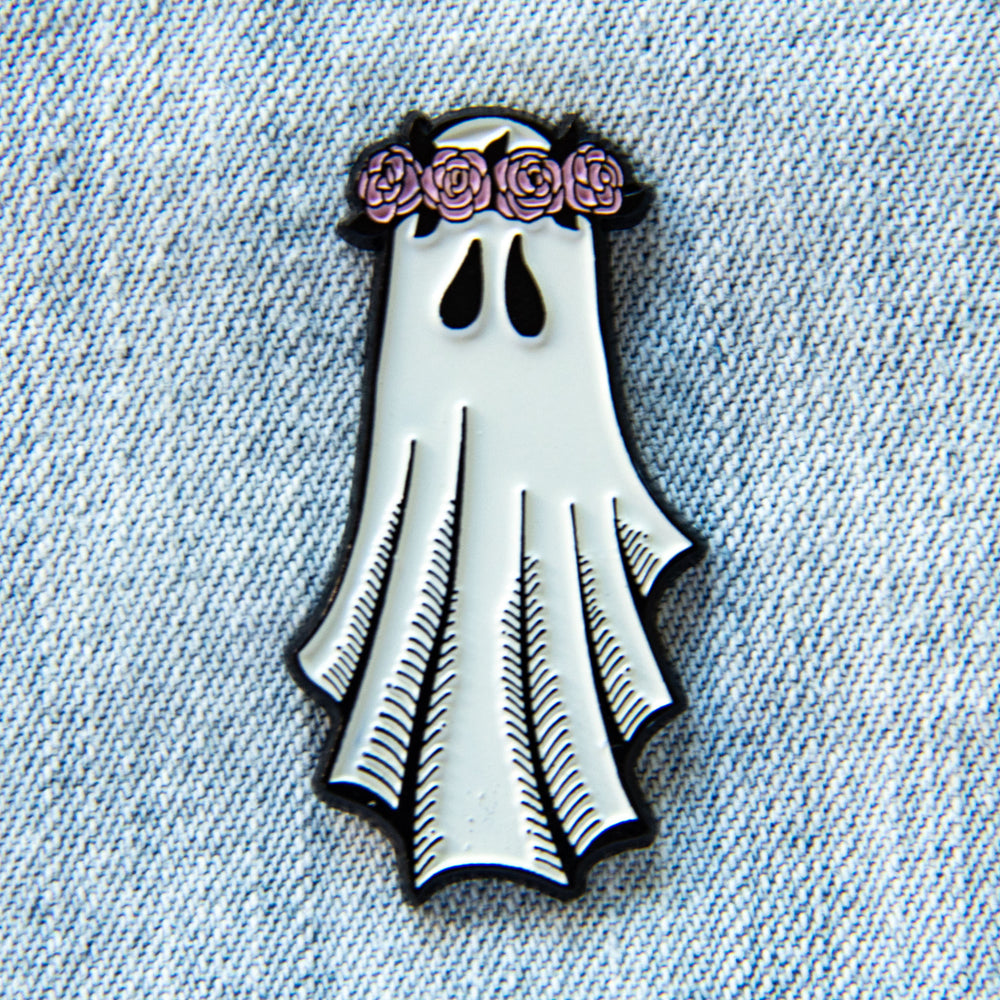 A cute enamel pin of a ghost wearing a pink flower crown for unique fashion.