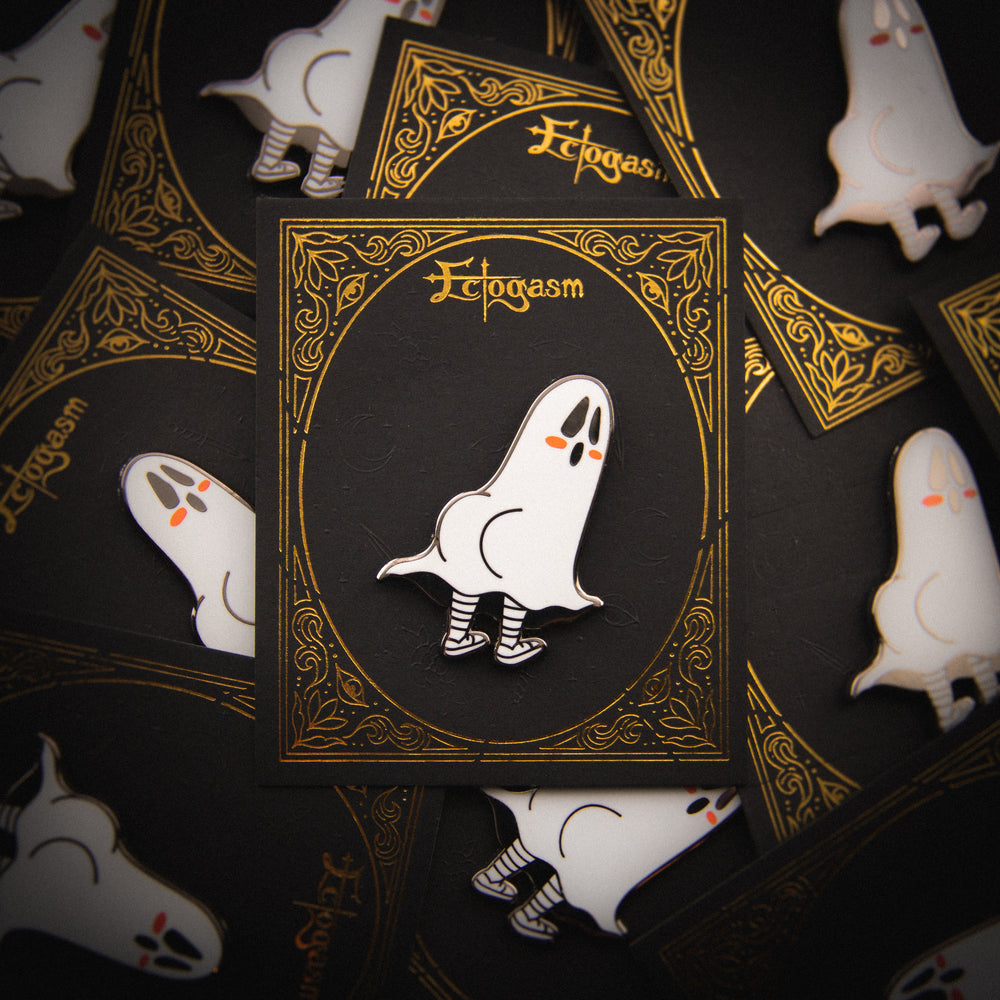 A gothic Ectogasm enamel pin on a black and gold card for wholesale. 