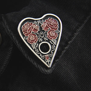 A black, silver, and red ouija board lapel pin accessory for women's witchy alternative fashion.