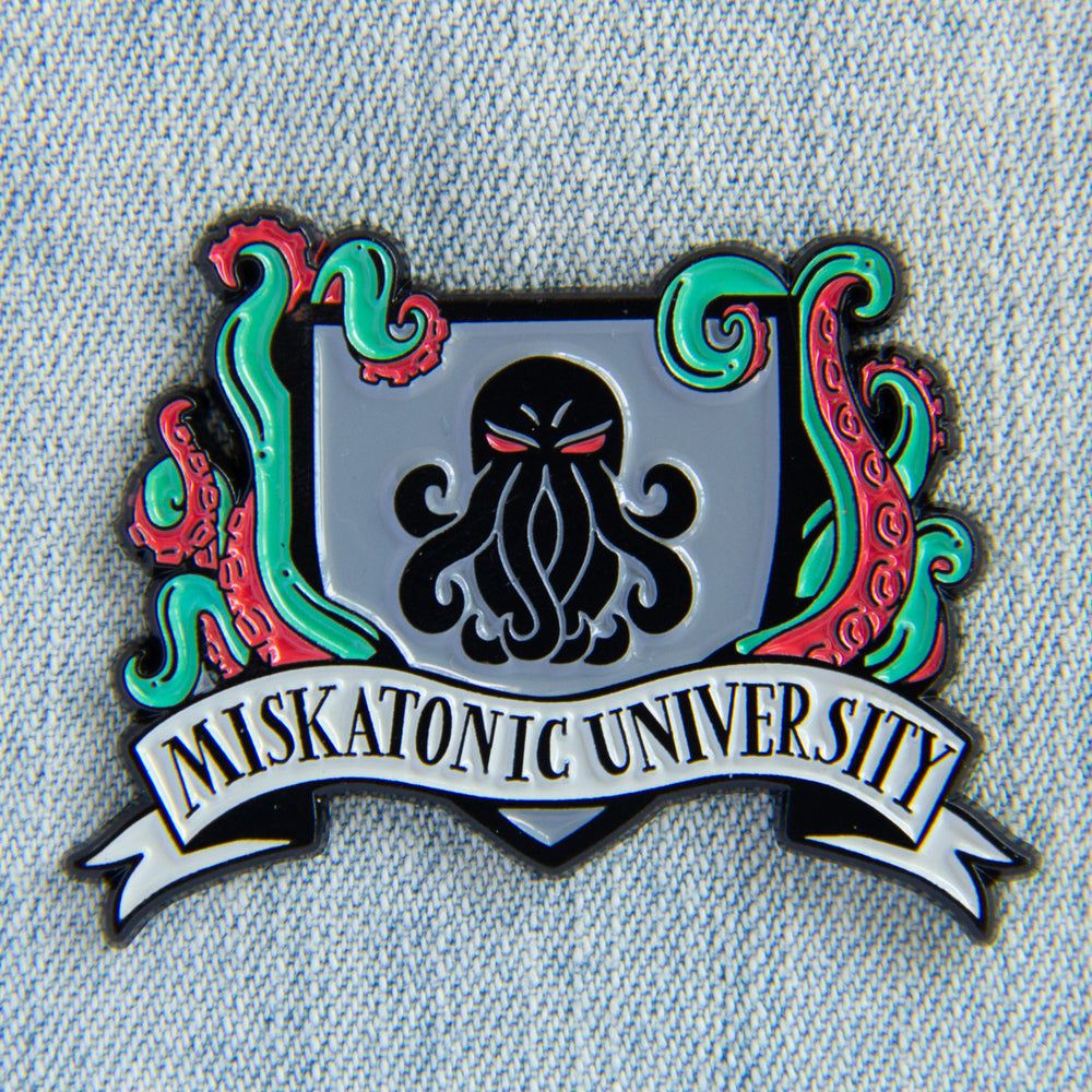 A unisex H.P. Lovecraft themed pin with tentacles and the Miskatonic University crest. 