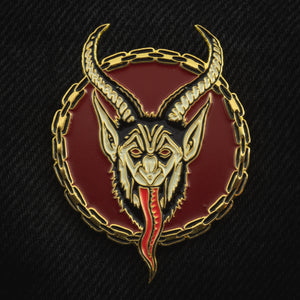 Ectogasm scary Krampus enamel pin in red and gold for a cool Christmas accessory.