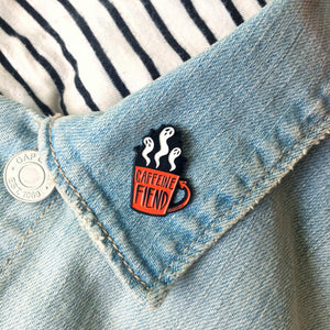 Ectogasm's coffee cup "Caffeine Fiend" pin on the lapel of a denim jacket for cool unisex fashion. 