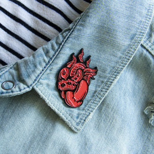 A tentacle enamel pin for unisex punk fashion. 