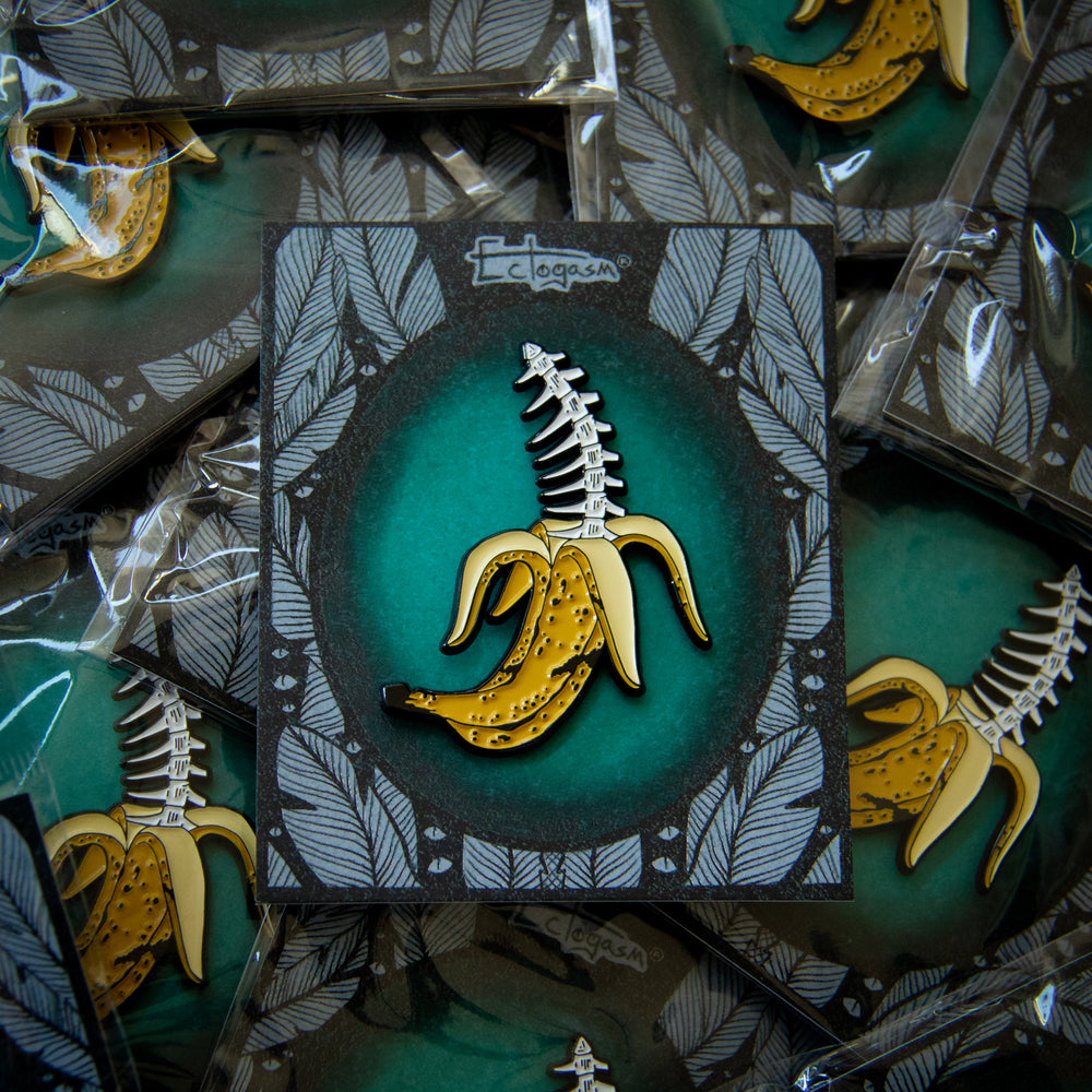 A spooky lapel pin of a banana with bones inside it.