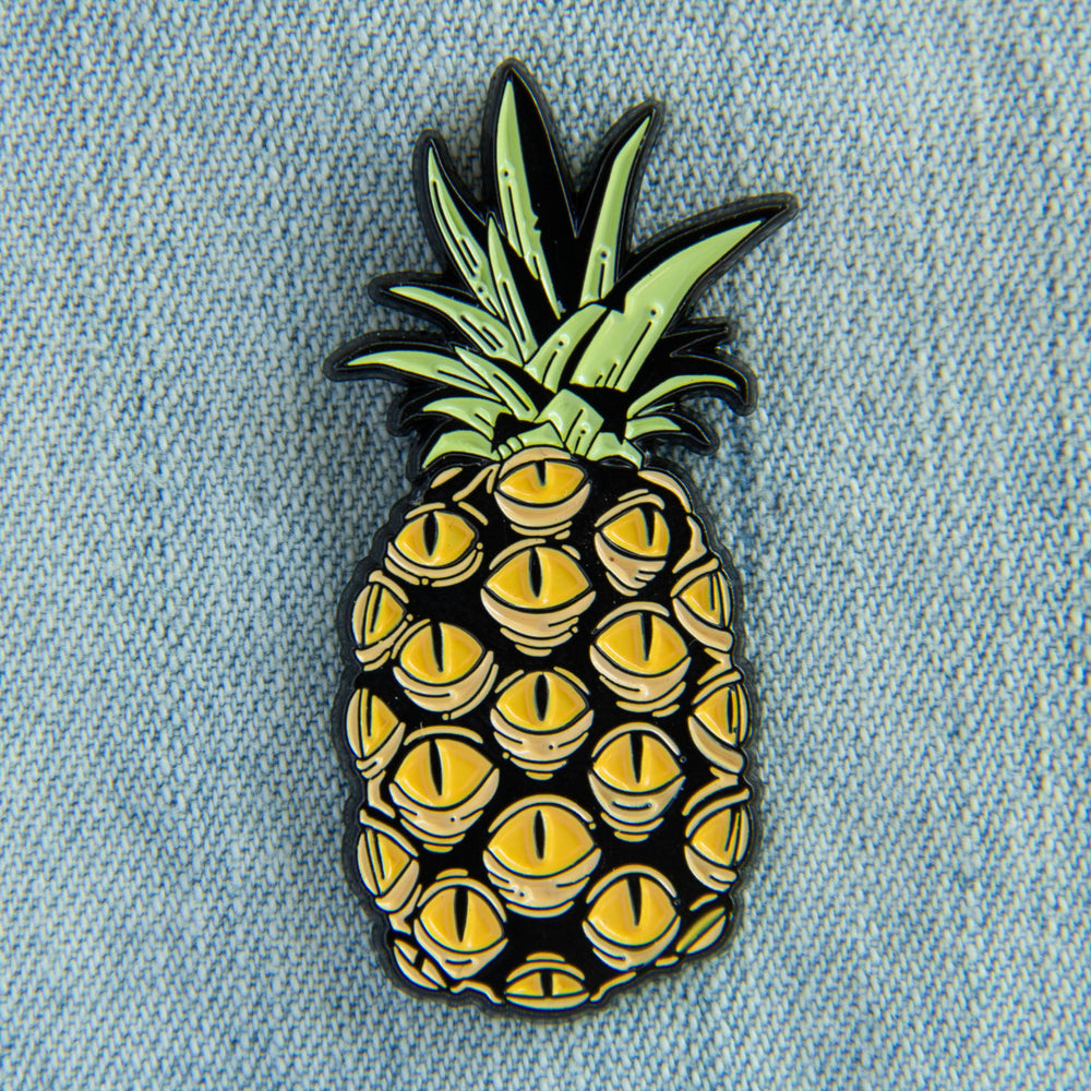 An oddity inspired accessory of a pineapple with creepy yellow eyes. 